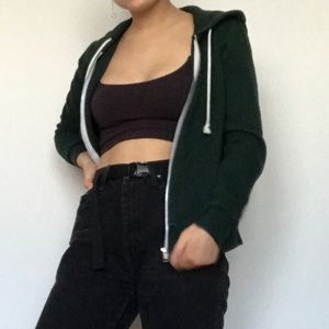 Green zip up hoodie.